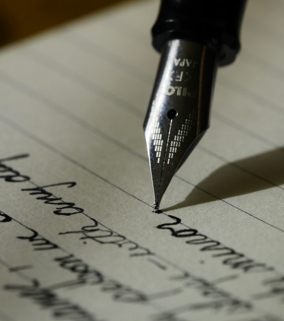 fountain pen on black lined paper